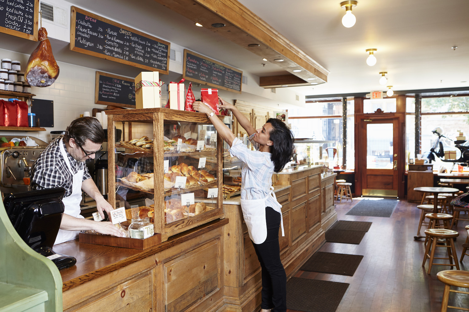 Male and female workers in bakery going about business